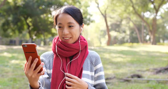 Woman making video call in the park