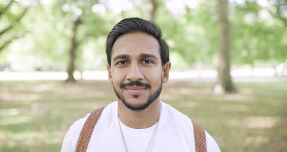 Portrait of smiling man in public park