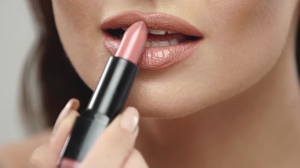 Closeup of Woman Applying Lipstick