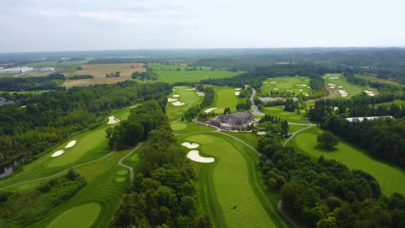 Drone shot of a large golf course in the countryside.