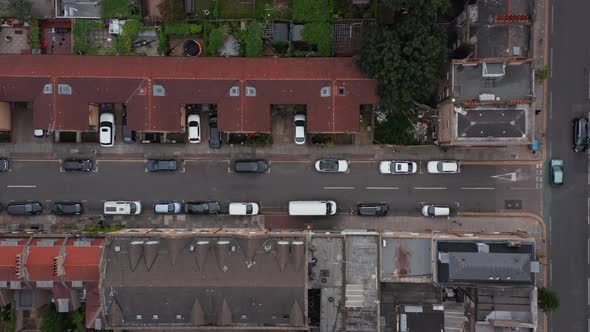 Aerial Birds Eye Overhead Top Down Descending View of Street in Residential District with Cars