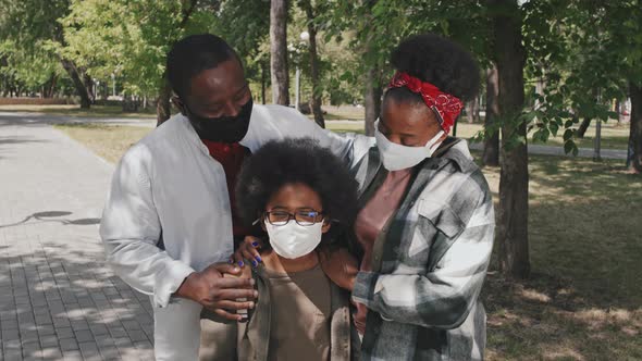 Portrait of African American Family in Face Masks Outdoors