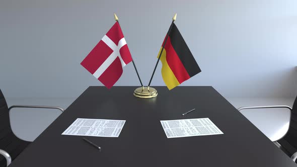 Flags of Denmark and Germany and Papers on the Table