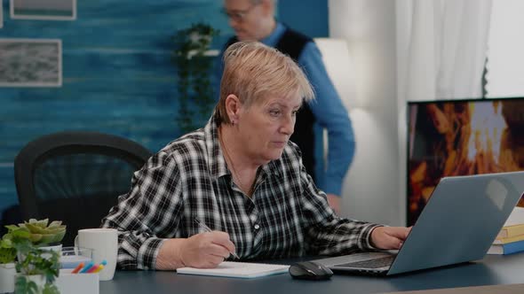 Old Woman Entrepreneur Checking Financial Project Taking Notes