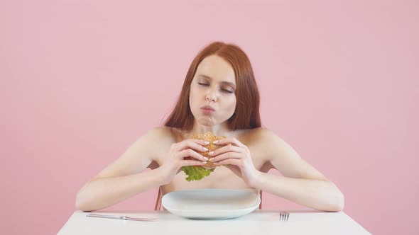 Happy Anorexic Girl Greedily Eating a Burger