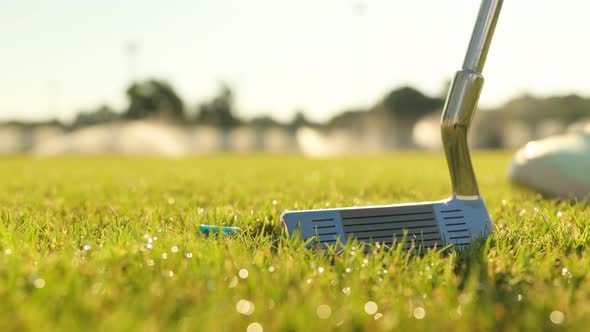 Hand in Glove Placing Golf Ball on Tee