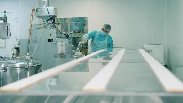 Male Pharmacologist Is Examining Factory Equipment