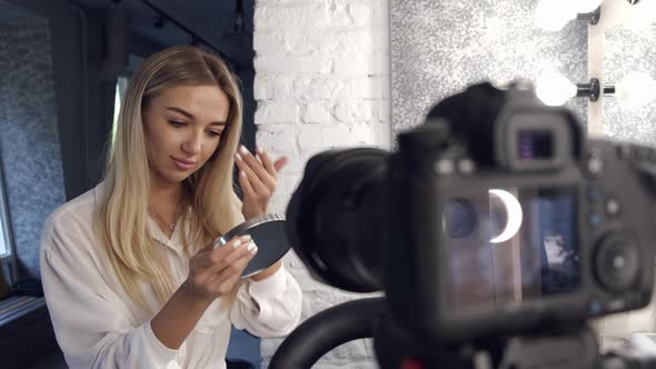 A Makeup Artist Is Doing Her Makeup on Camera