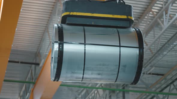 Loading Sheet Metal in a Warehouse Using a Crane and an Electromagnet