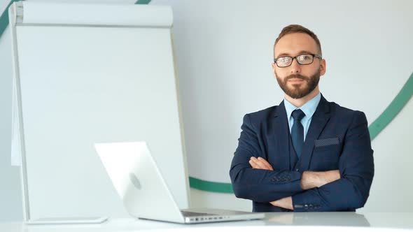 Portrait of Successful Businessman Entrepreneur Looking at Camera in White Office