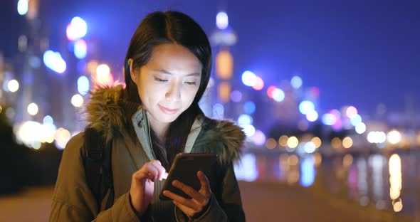 Young Woman Use of Smart Phone in City at Night