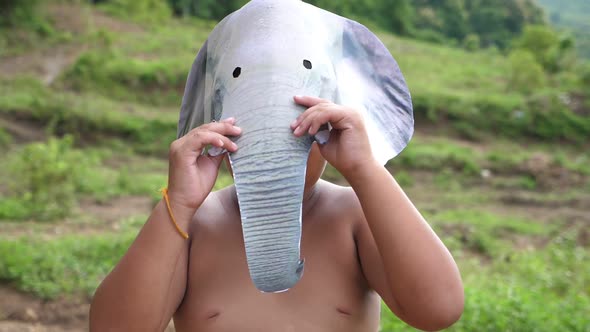 Asian Boy Wearing Elephant Mask