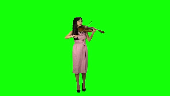 Girl of Asian Appearance Playing the Violin. Green Screen