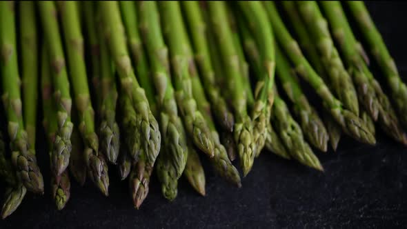 Closeup of fresh green asparagus on rustic black board