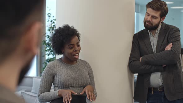 African Businesswoman Telling Funny Story to Coworkers