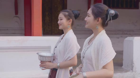 Girls In Thai Traditional Dress Walking With The Water Bowl