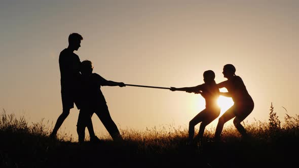 Children and Adults Compete in Tug of War, a Healthy and Active Lifestyle