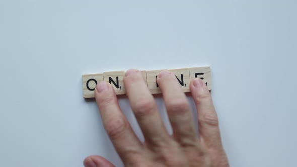 Fingers Moving Word Online Composed From Separate Wooden Letters on White Background