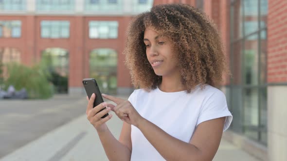 African Woman Browsing Internet on Smartphone