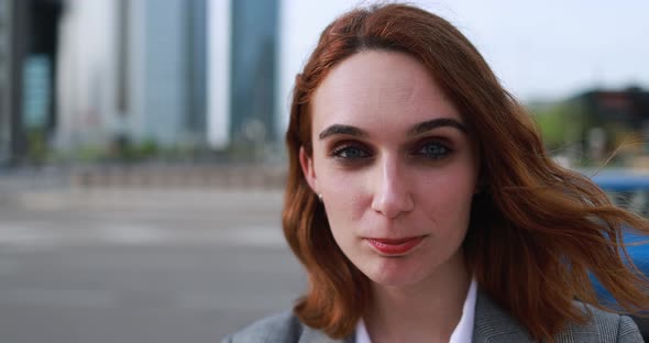 Young business woman working outside of the office with city in background