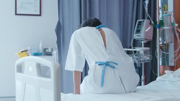 Female patient sitting on a hospital bed