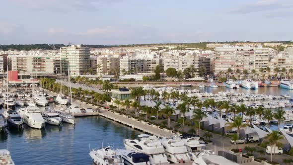 Puerto Santa Pola, Alicante, Spain. Boats And Yachts In Spanish Harbor Near Coastal Town Buildings.