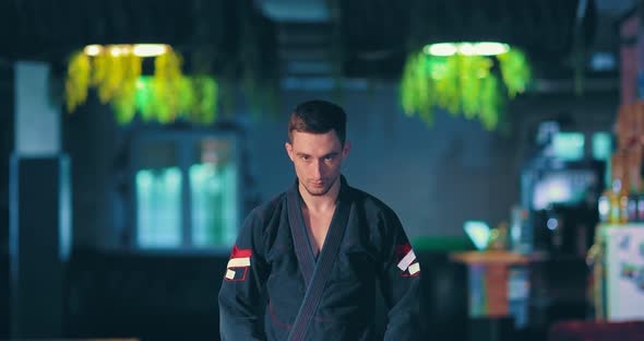 Judo Fighter Looks at the Enemy Before the Fight, a Serious Menacing Look. Portrait View.