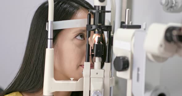 Young Woman checking on eye in clinic