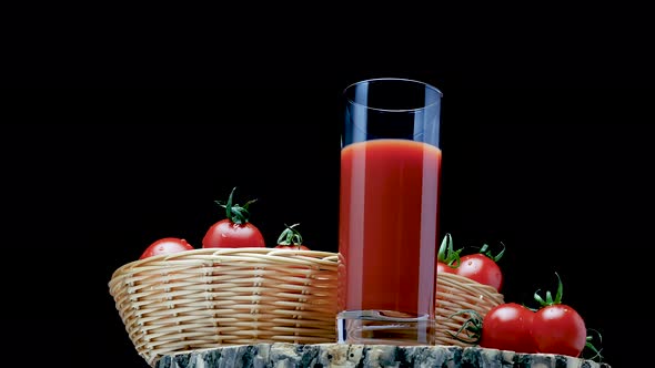 Pour Natural Tomato Juice Into A Glass On A Black Background. Fresh Tomatoes With Tomato Juice