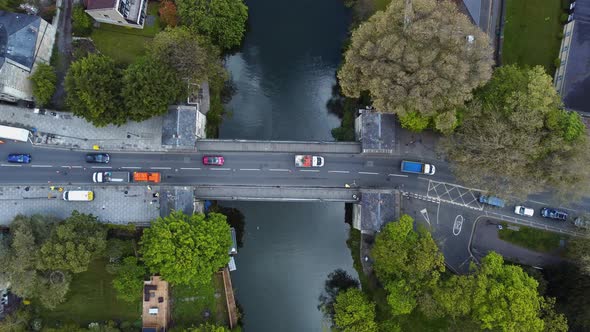 Top down aerial of european town bridge over a significant river. Traffic flows in one direction, wi