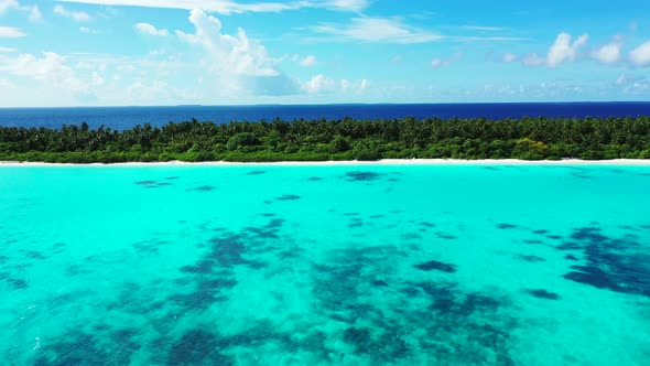 Luxury birds eye copy space shot of a sandy white paradise beach and aqua blue water background in v