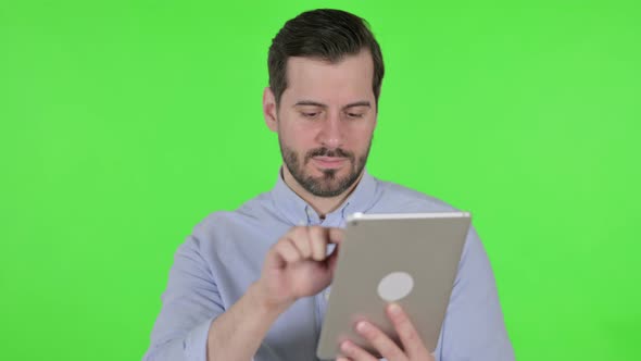 Portrait of Attractive Man Using Tablet in Cafe Green Screen