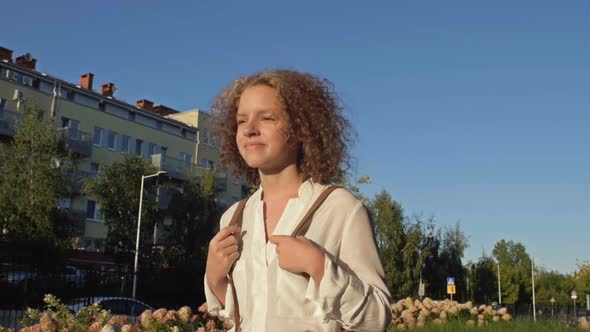 Cute Teenage Schoolgirl Goes to School After Summer Vacation