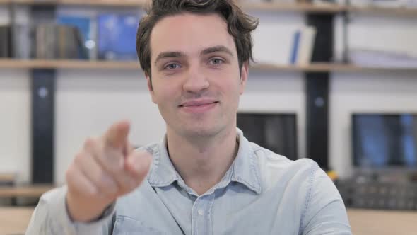 Man Pointing Toward Camera