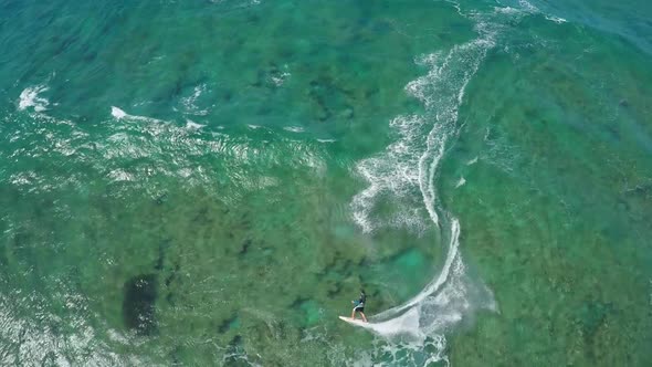 Aerial view of a man kitesurfing in Hawaii