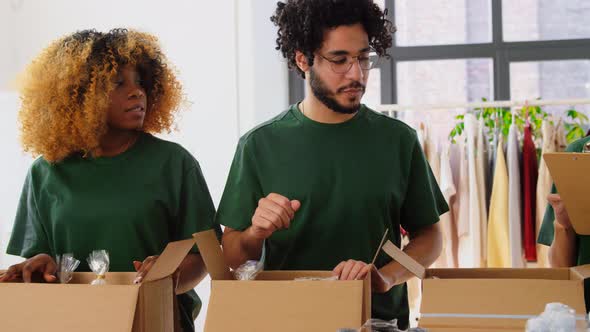 Happy Volunteers Packing Food in Donation Boxes