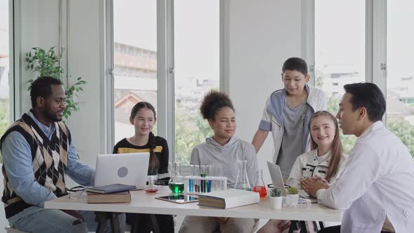 Teacher asking science question and girl raise hand up to answer