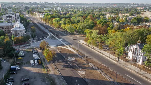 Construction Site of Avenue with Asphalt Paver Roller and Truck Aerial Timelapse