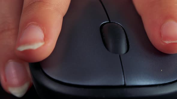 A Woman Uses a Computer Mouse - Closeup From the Front