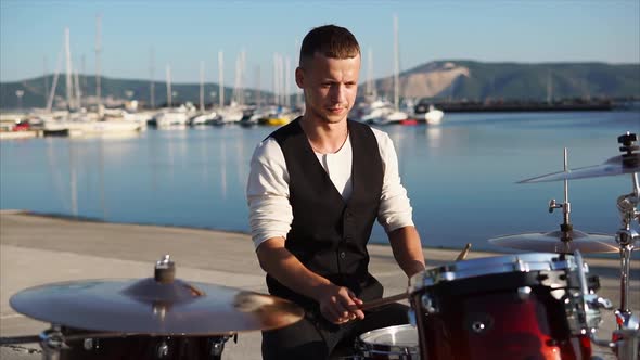 Drummer Performing During Outdoor Concert in Harbour