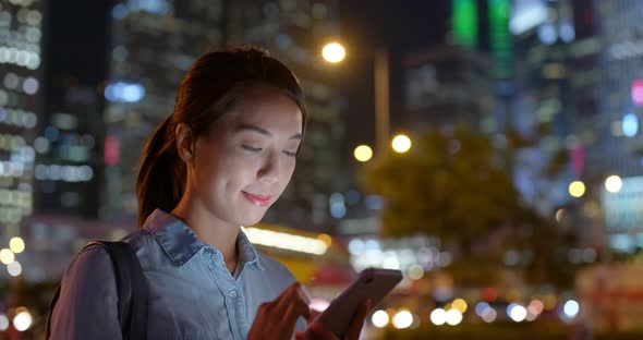 Woman use of mobile phone online at night