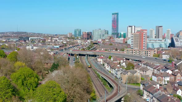 Drone shot towards central croydon national rail train passing through