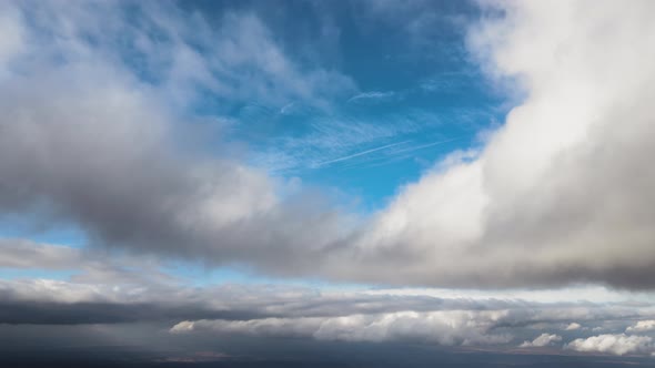 Aerial View From High Altitude of Earth Covered with Puffy Rainy Clouds Forming Before Rainstorm