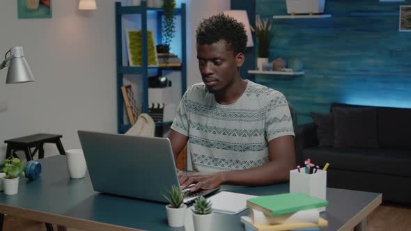 Business Man of African Ethnicity Using Laptop for Online Remote Work