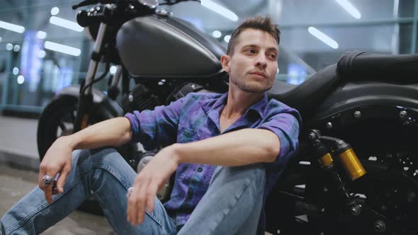 Portrait of Young Attractive Man Motorcyclist on Night Street