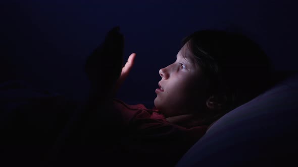 Little Girl Using Smartphone at Night