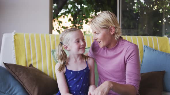 Font view of Caucasian woman playing with her daughter at home