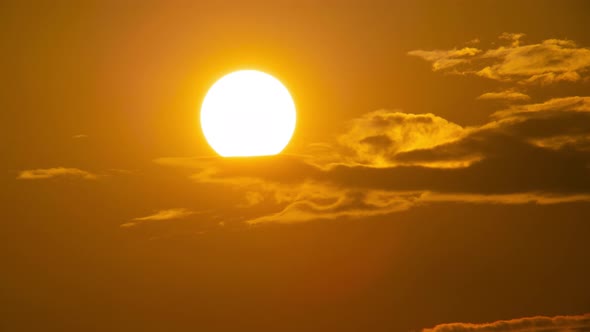 Telephoto lens Close up the sun in sunset Dramatic sky time-lapse 4k. Clouds and Sun Rising Sky