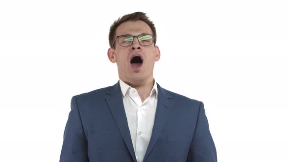 Handsome Male Entrepreneur in Blue Suit and Glasses Feeling Tired Yawning and Covering Opened Mouth