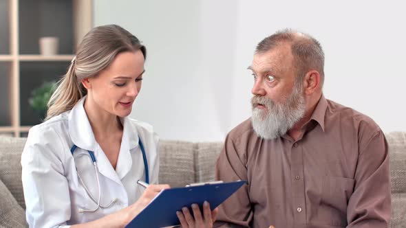 Happy Female Nurse Consulting 80s Grandfather Medical Health Treatment at Nursing Home